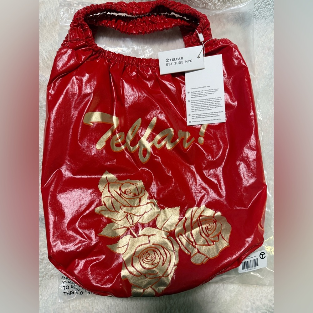 Telfar Plastic Bag in red with gold floral pattern